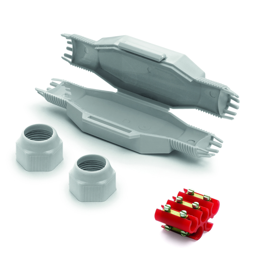 Längliche graue Mikro-Verbindungsmuffe, halb geöffnet, mit Gel gefüllt. Davor liegen eine Schraubklemme und Verschlüsse.